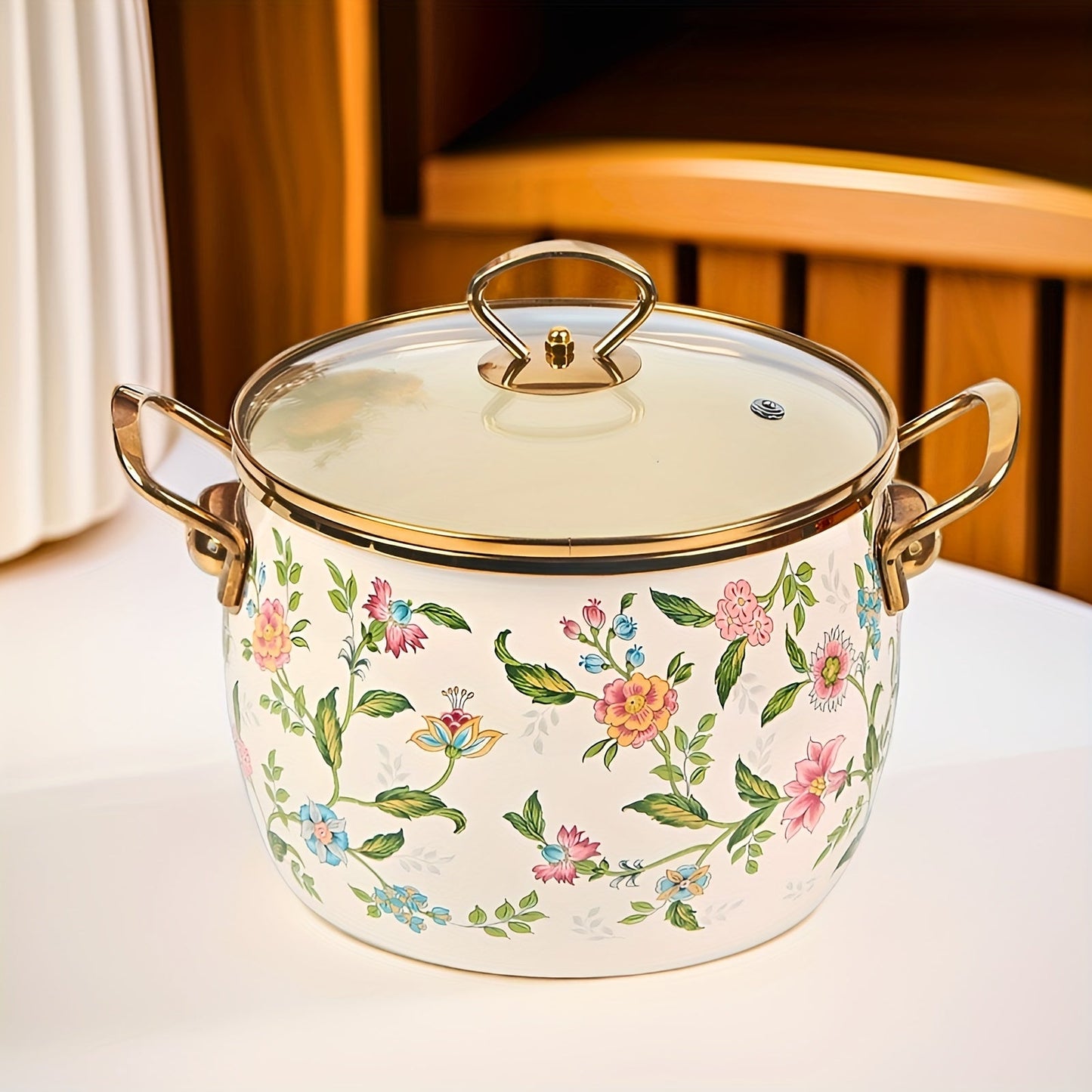 Large capacity enamel saucepan with glass lid and floral design is a non-stick, dishwasher-safe kitchen cookware with double handles. This soup pot features a golden handle for added style and convenience.