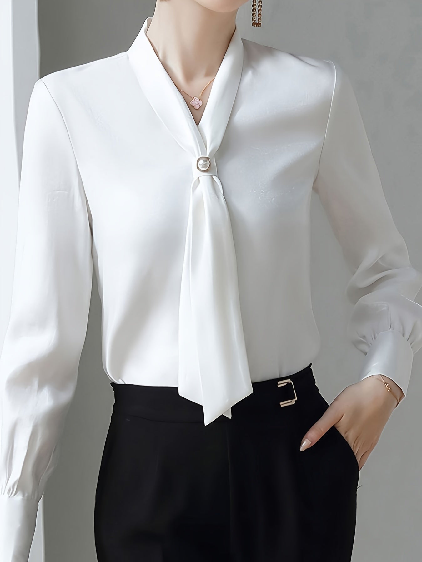 Beaded V-neck blouse with elegant long sleeves for spring and fall.