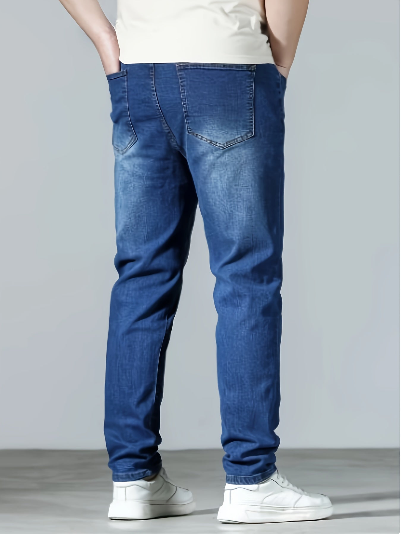 Plus size men's casual skinny fit denim jeans with medium stretch, solid color, pockets, suitable for all seasons.