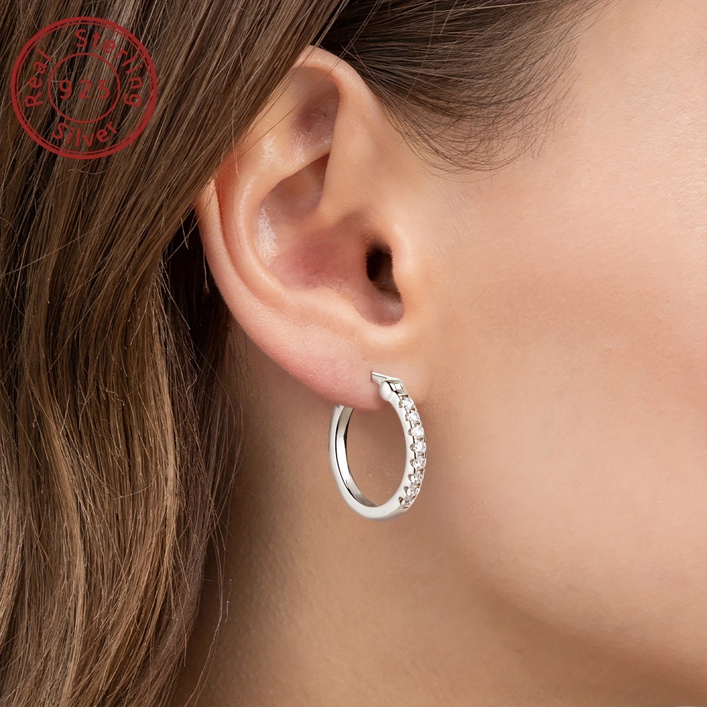 These elegant earrings are crafted from 925 sterling silver and feature a pair of round Moissanite stones. Each earring weighs approximately 3.94g and is adorned with 16 pieces of 1.8mm Moissanite stones, totaling 0.4 carats per pair. Perfect for adding