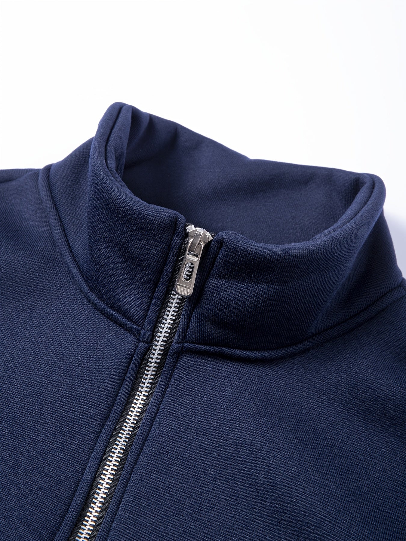 Men's casual half-zip pullover sweatshirt in solid color, made of 100% polyester knit fabric with a slight stretch. Features a stand collar, long sleeve, zipper detail, and regular fit.