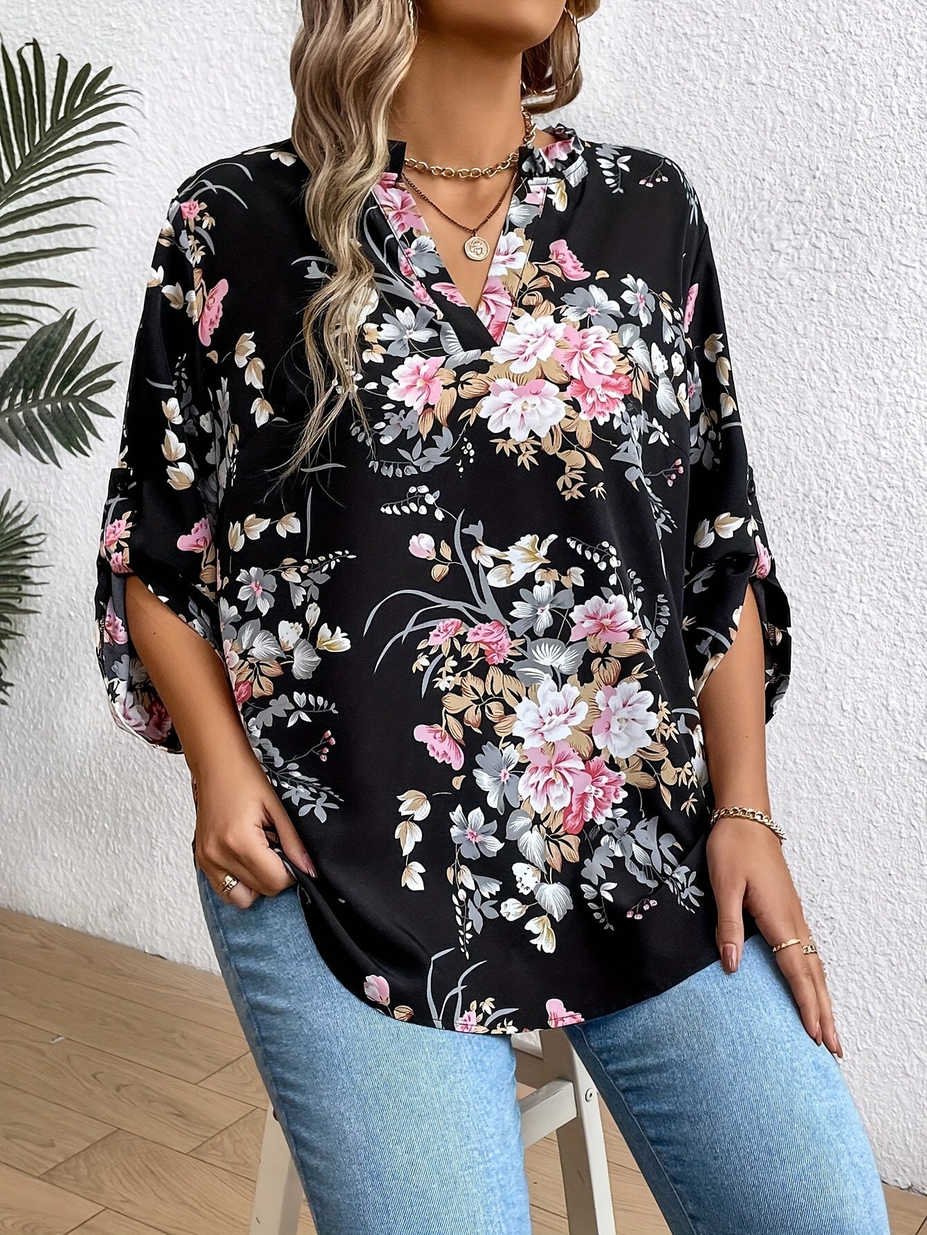 Elegant plus-size women's floral print blouse with ruffle sleeves in stylish black, perfect for casual to semi-formal occasions.