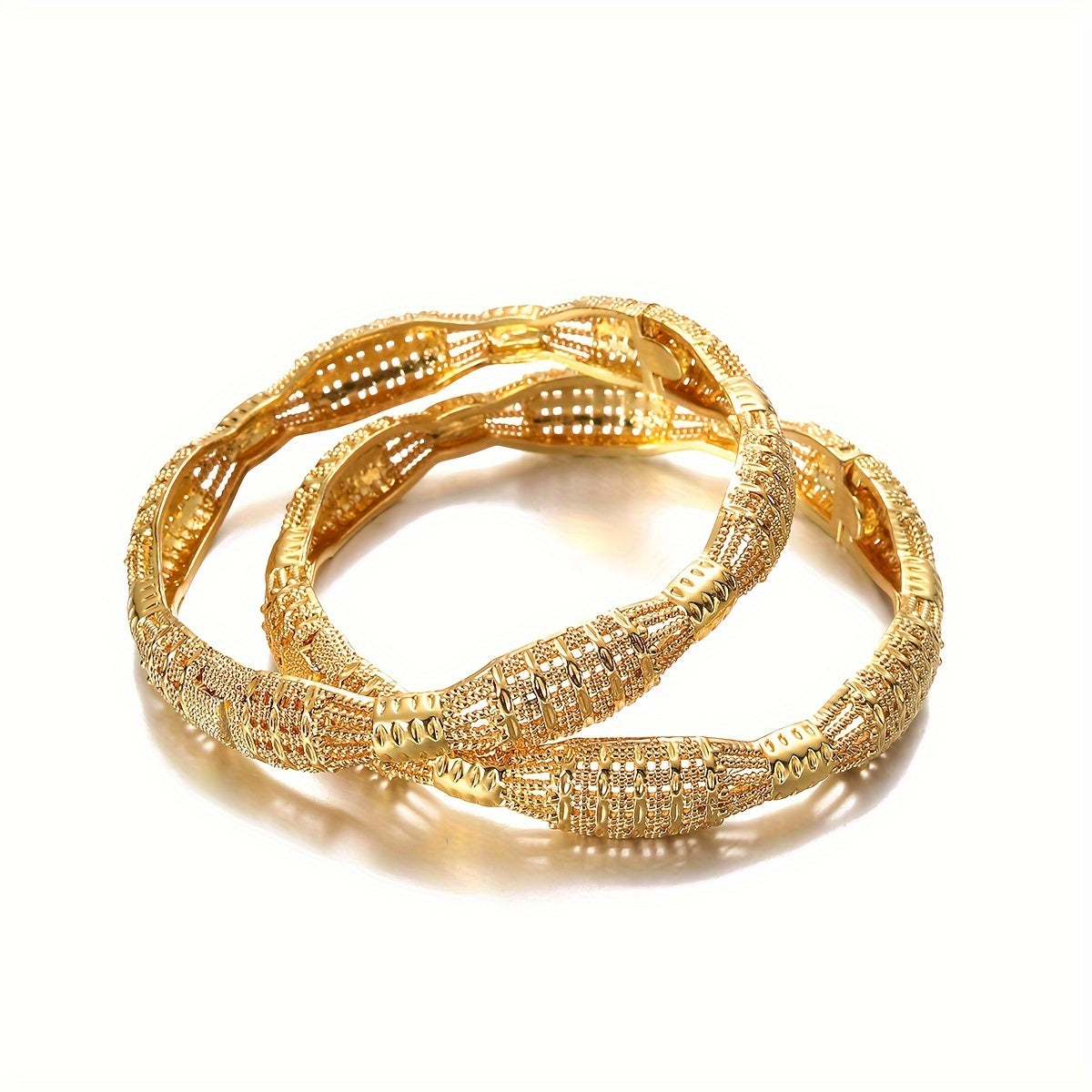 Vintage and sexy, this set of two golden Ethiopian bangle bracelets is perfect for women. Made of alloy, they are ideal for both casual attire and special occasions.