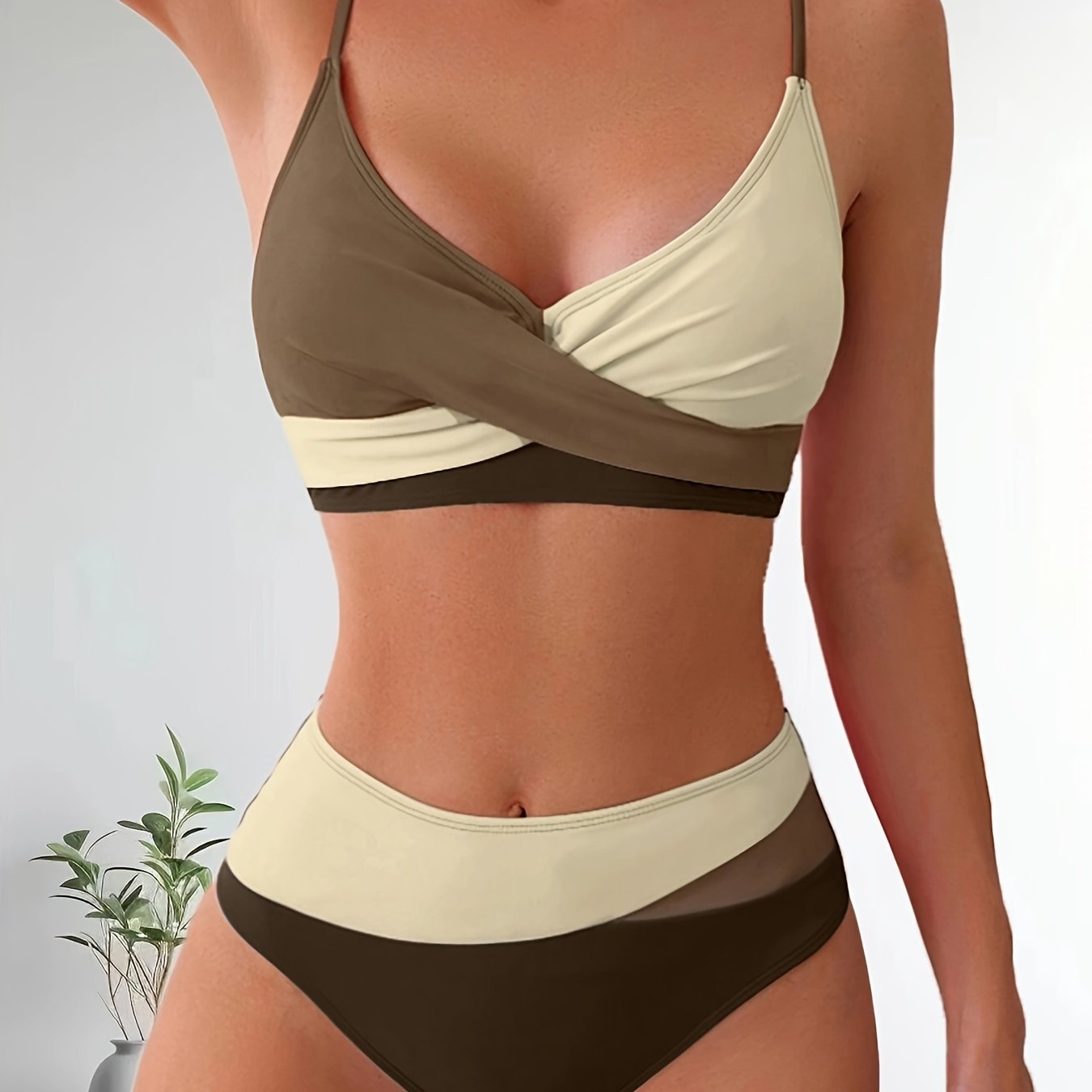 Patchwork two-piece swimsuit with crossed colors and high-waisted design.