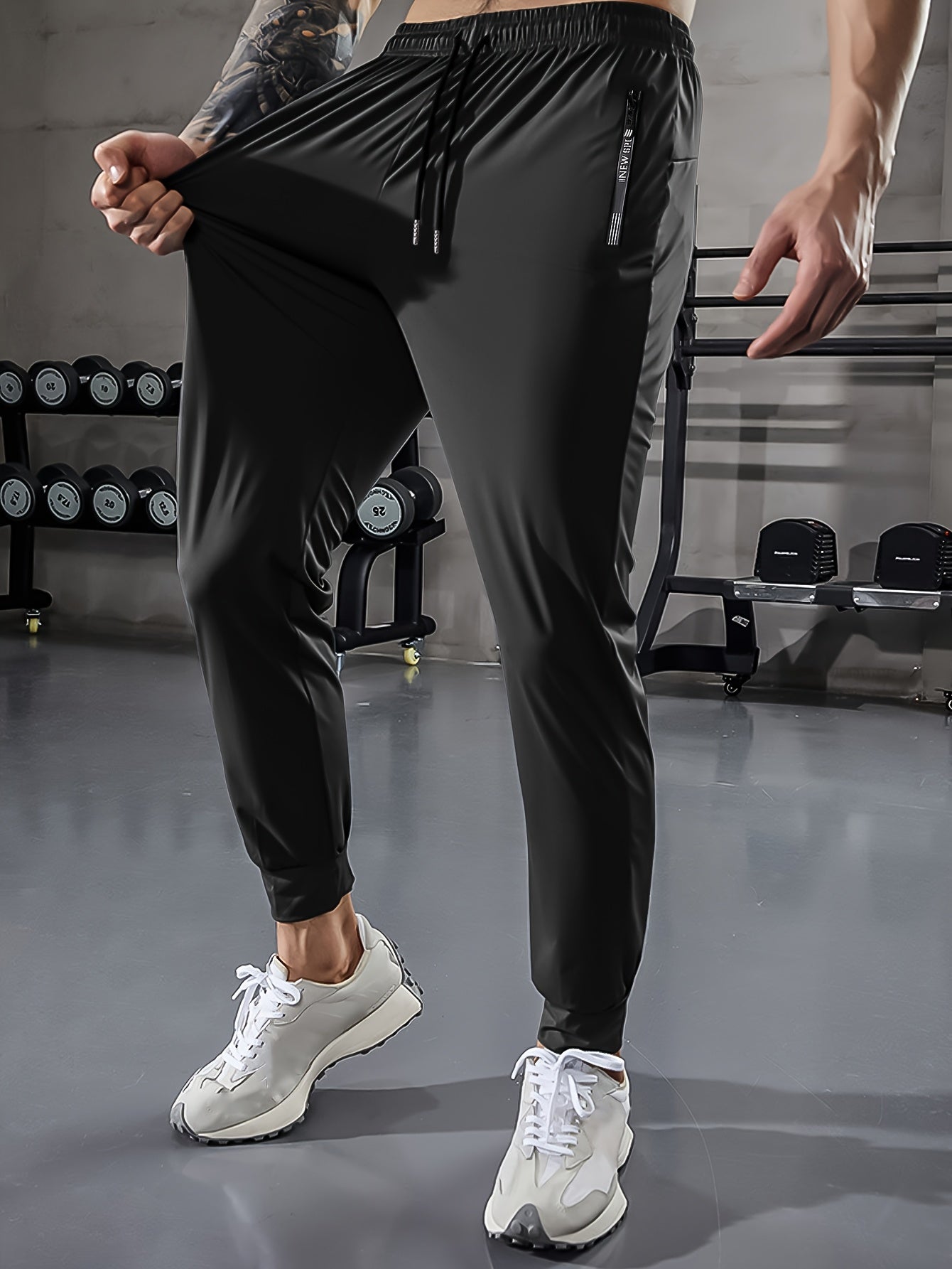 Men's athletic stretch pants with adjustable drawstring waist, zippered pockets, solid color, quick-dry material, ideal for fitness and running.