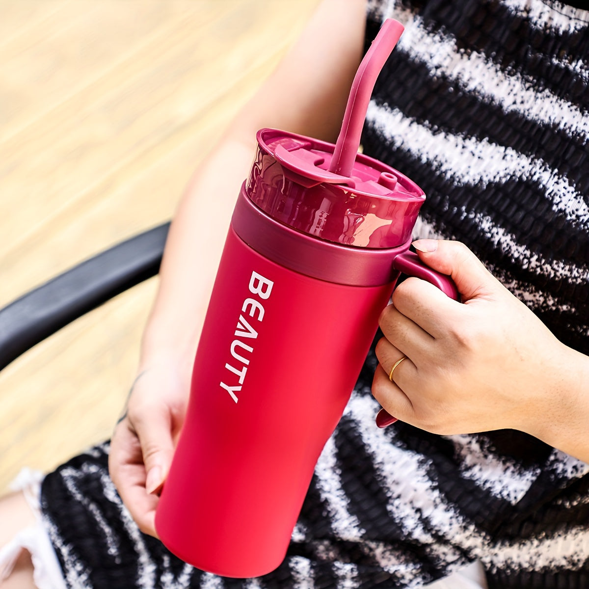 The BEAUTY Portable Water Bottle with Straw is large, lightweight, and suitable for hiking. It is made of plastic and has a round shape, and should be hand washed.