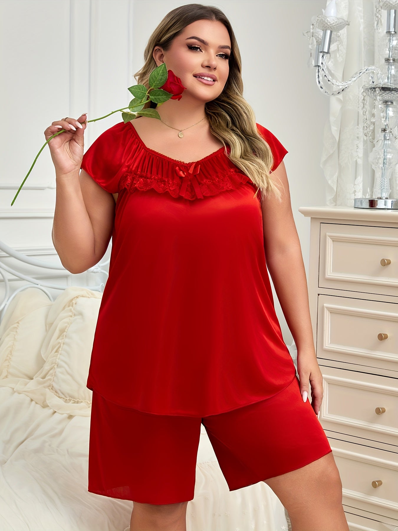 Elegant women's pajama set with bow detail, made of soft polyester and elastane blend. Includes short sleeve top and shorts, easy to care for with machine wash.