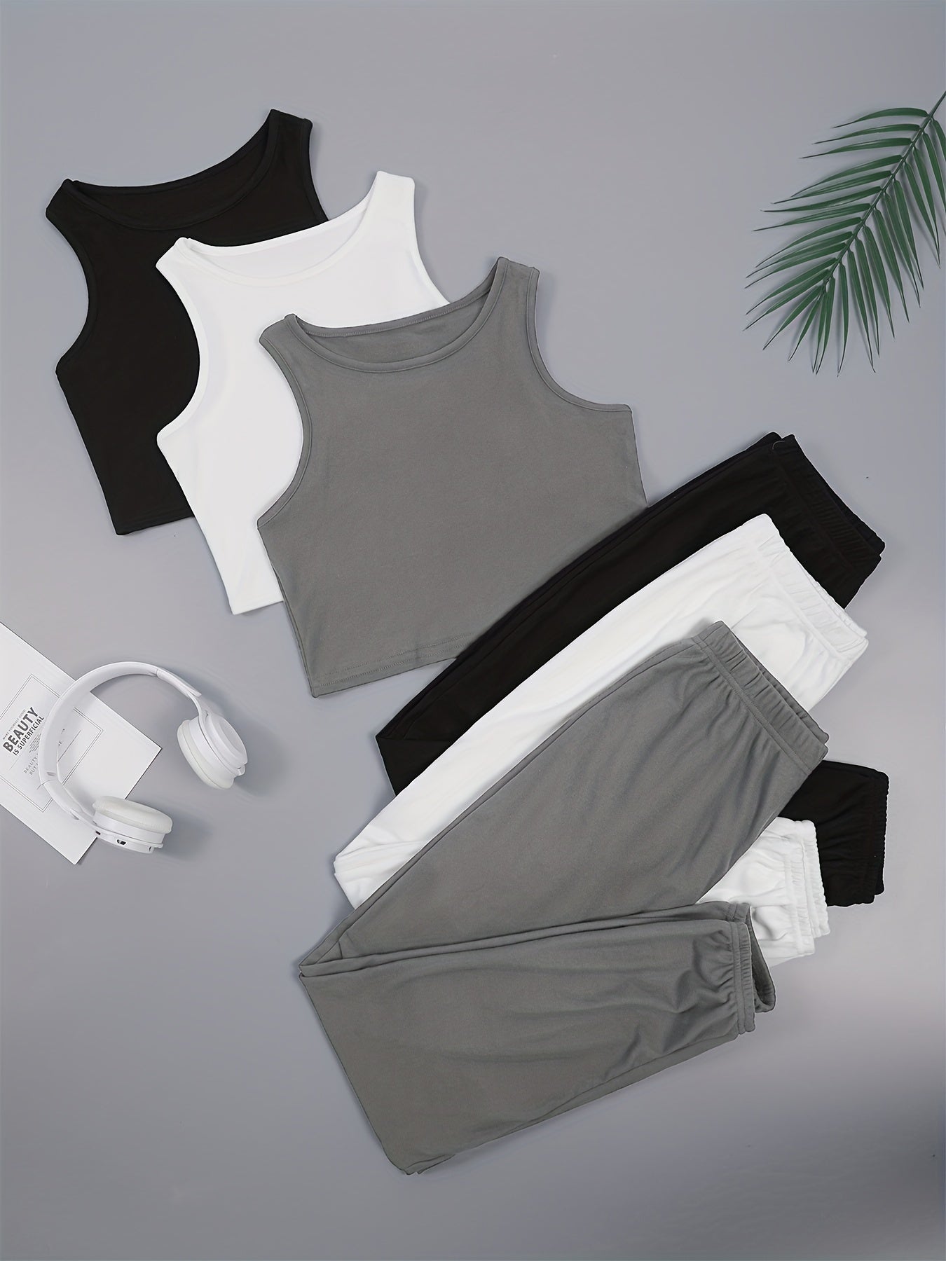 Three sets of women's solid color vest and shorts pajama sets.