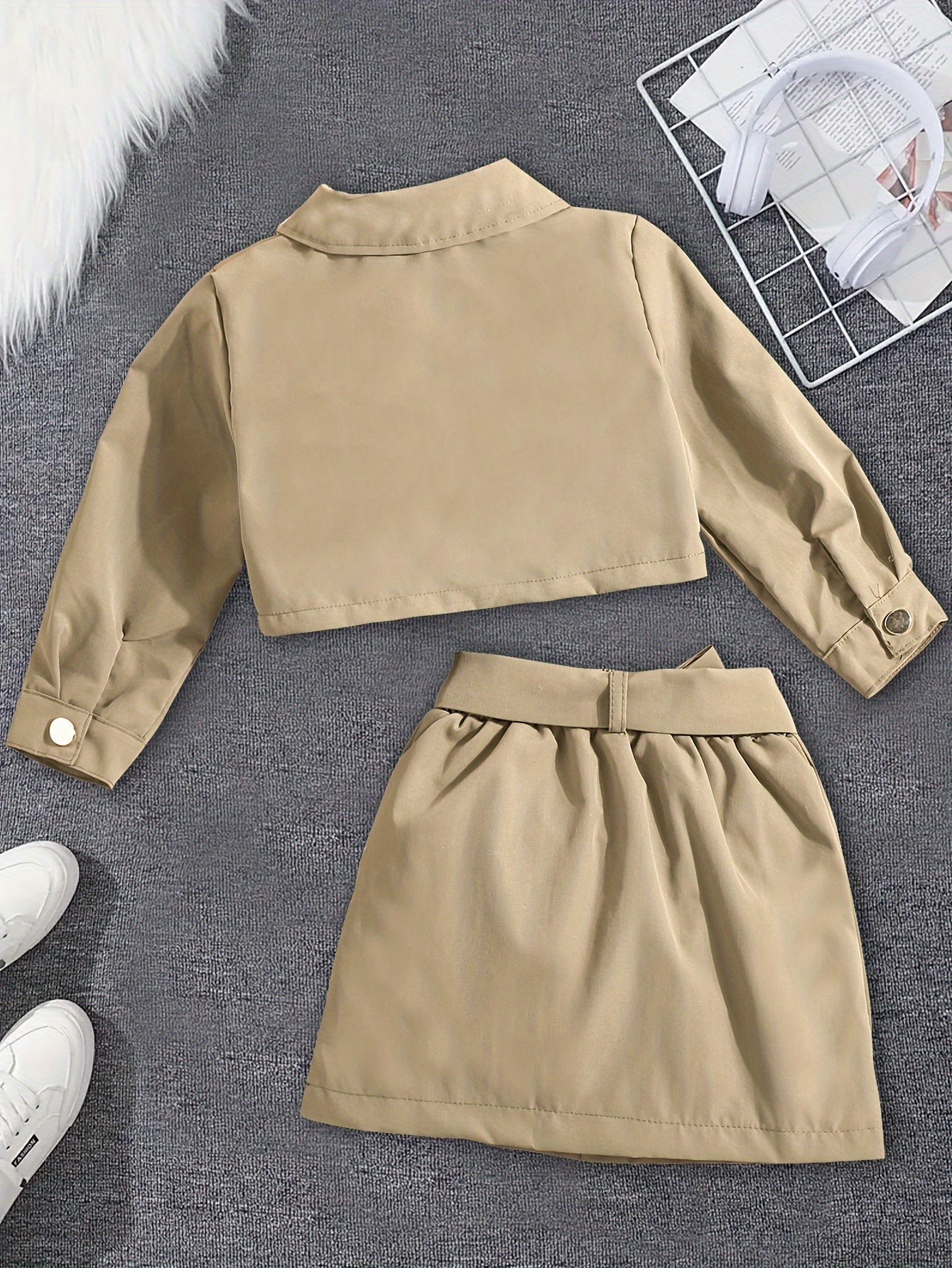 Stylish girls' top and skirt set with button detail, belt, and solid color, ideal for spring/fall