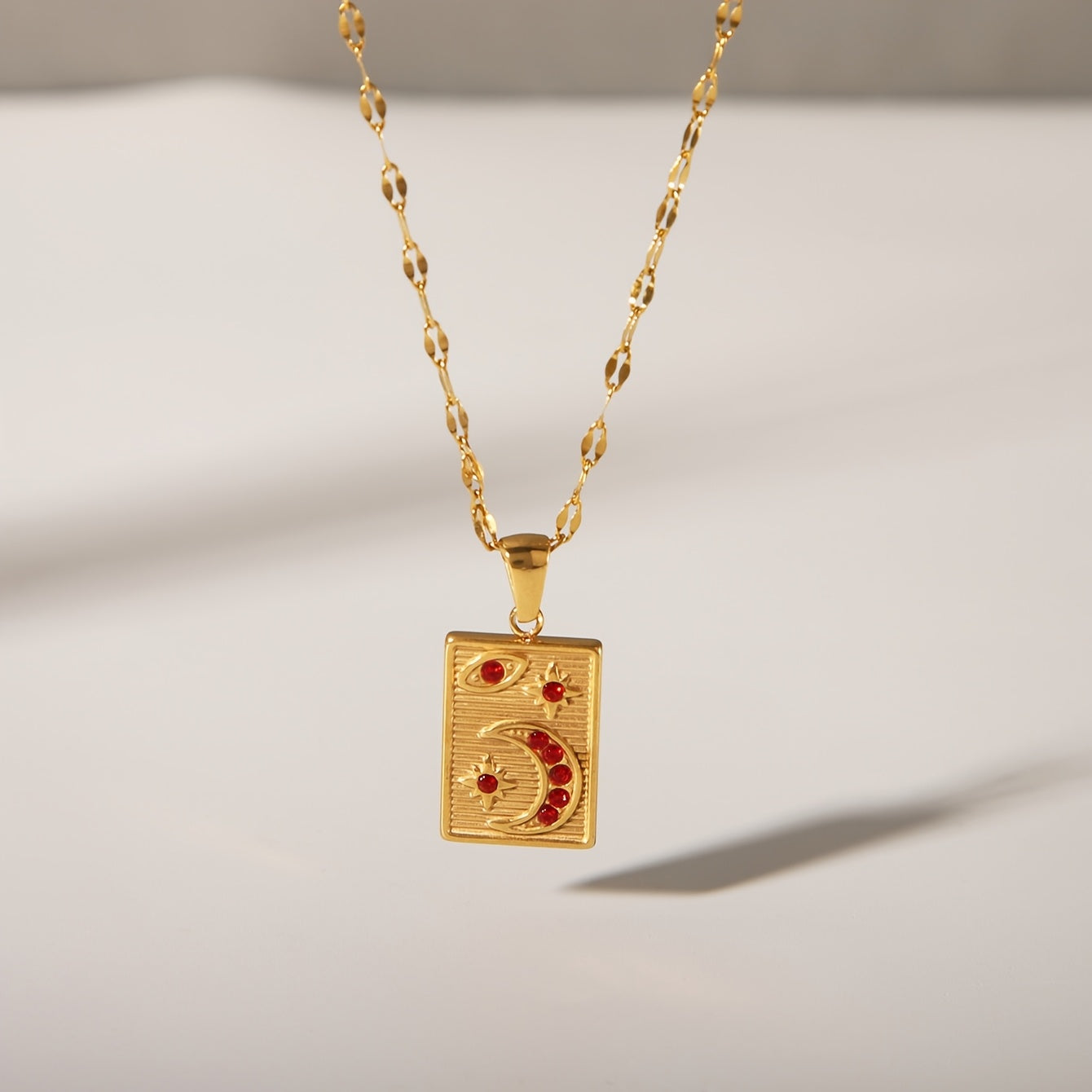 18K Golden Plated Stainless Steel Pendant Necklace featuring a Minimalistic Geometric Rectangle & Crescent Moon Design adorned with Red Synthetic Zirconia Stones, a Stylish and Versatile Piece of Fashion Jewelry perfect for Women to Wear on Both Daily