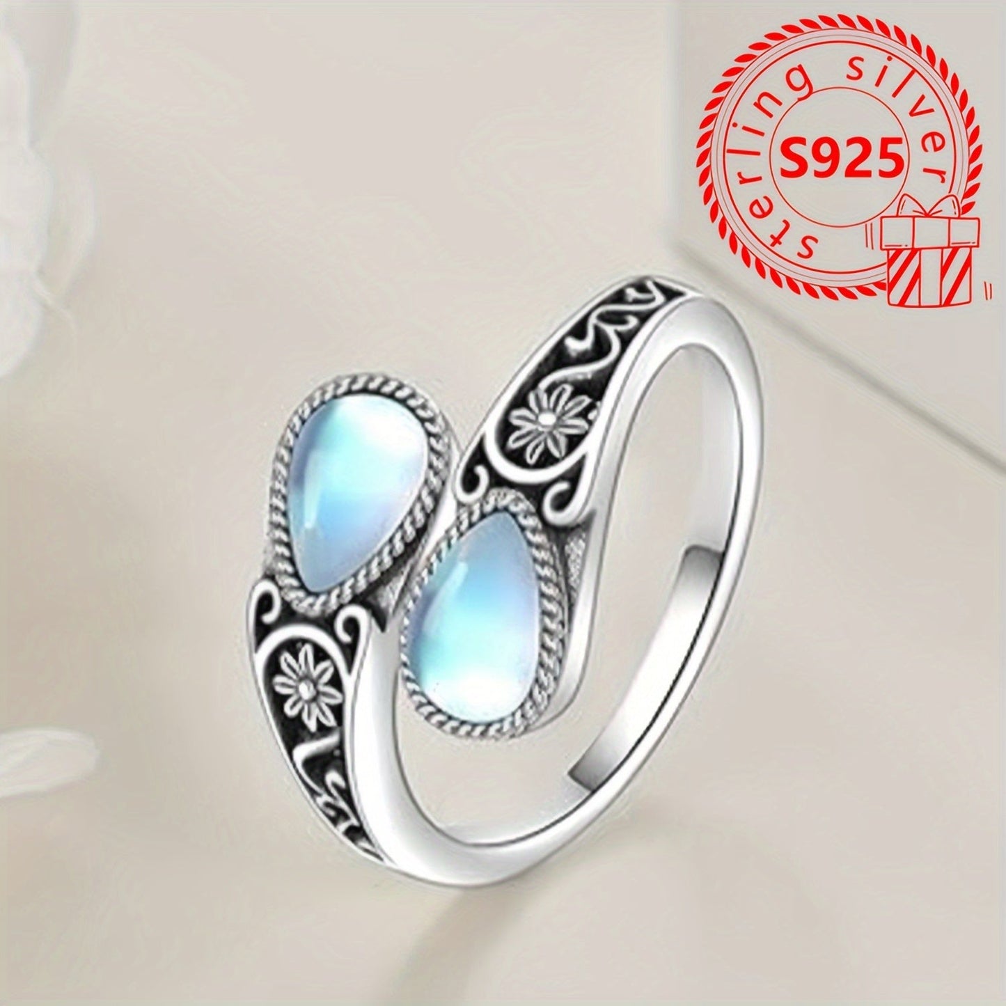 This ring features a moonstone set in an S925 pure silver spoon-shaped setting, weighing 3.6g and free of nickel. It has a hypoallergenic, vintage-inspired design with a Victoria retro style and is adjustable to fit the thumb. Perfect for a bohemian