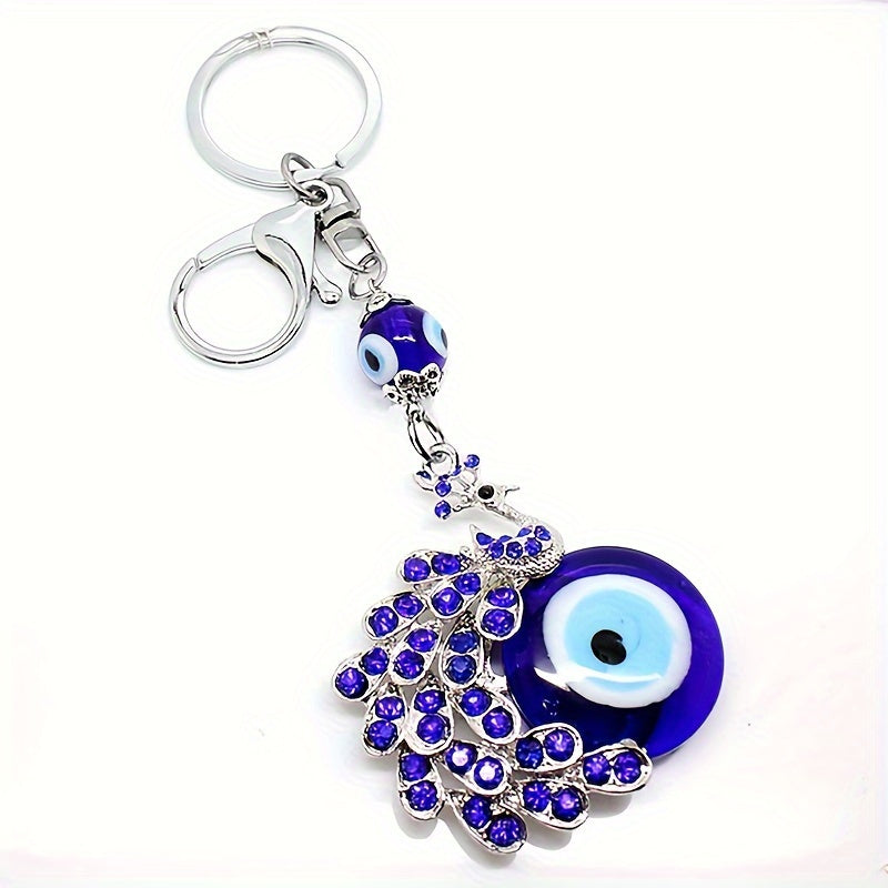 Blue Evil Eye Keychain with Rhinestone Inlaid Peacock Design, made from Alloy, Perfect for Women's Daily Use as a Trendy Hanging Pendant or Bag Charm.