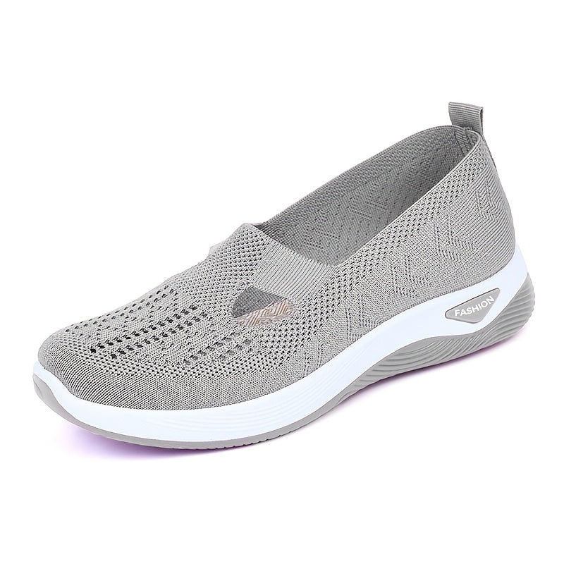 Breathable mesh slip-on sneakers for women with a comfortable PVC sole and loose fit.