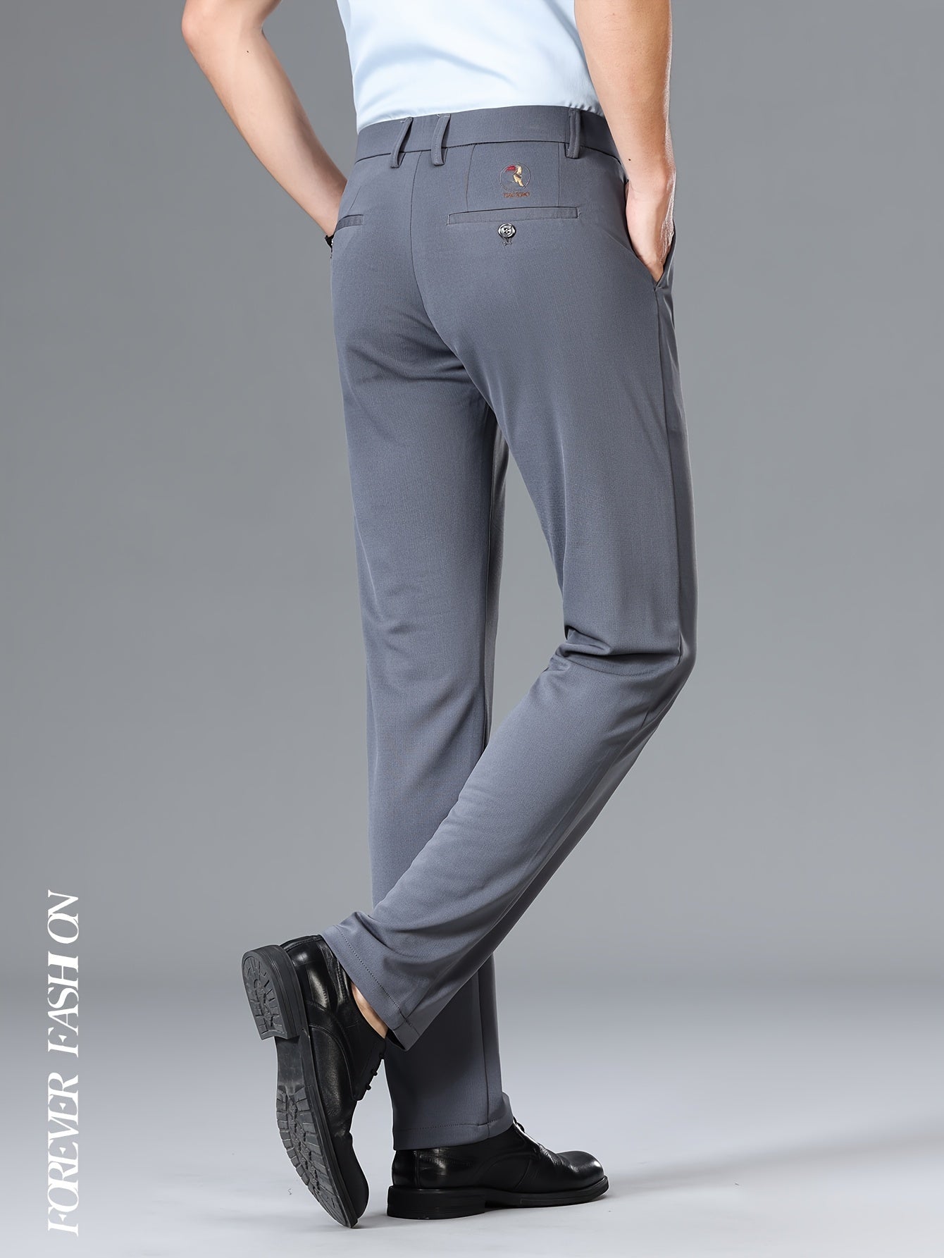 Stretchy black dress pants with bird emblem for men, slim fit, machine washable for business casual and social events.