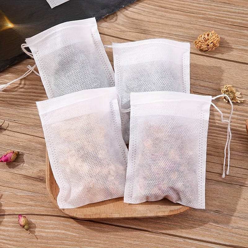 100 pieces of disposable drawstring tea bags made of non-woven material. These food-safe filter bags are perfect for brewing Chinese medicine, seasoning, straining soup, and separating residue.