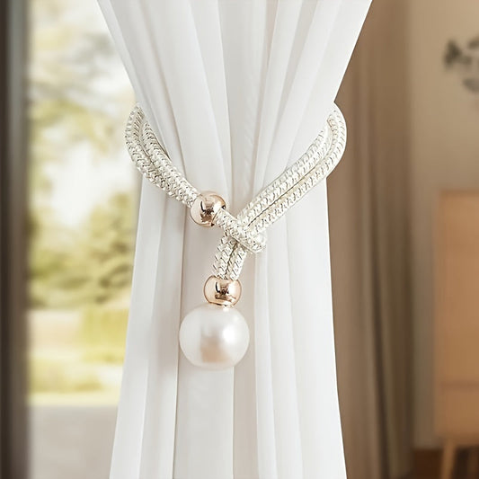 A faux pearl curtain tieback, perfect for holding back your living room curtains and adding a touch of elegance to your home or office decor. This decorative accessory is a stylish way to keep your curtains neatly stored when not in use.