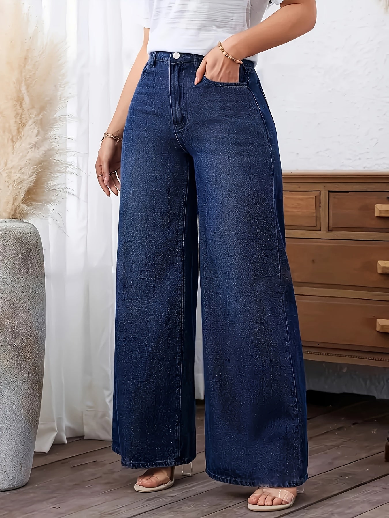 Women's plus size denim jeans with straight leg, solid color, medium stretch, washed fabric, and wide-leg design suitable for all seasons.