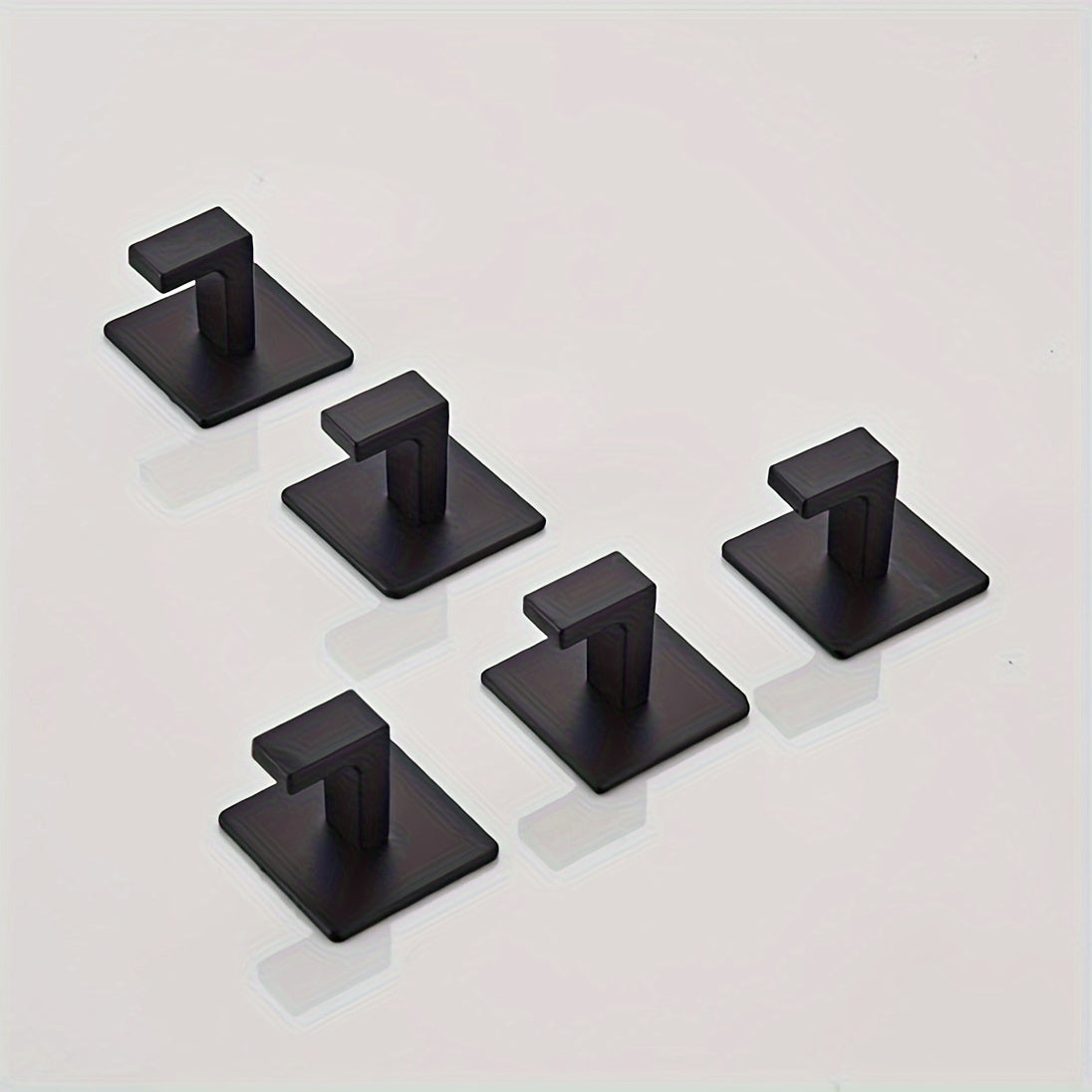 Self-adhesive wall hook for hanging keys, bags, clothes, bathrobes, coats, towels, and other accessories.