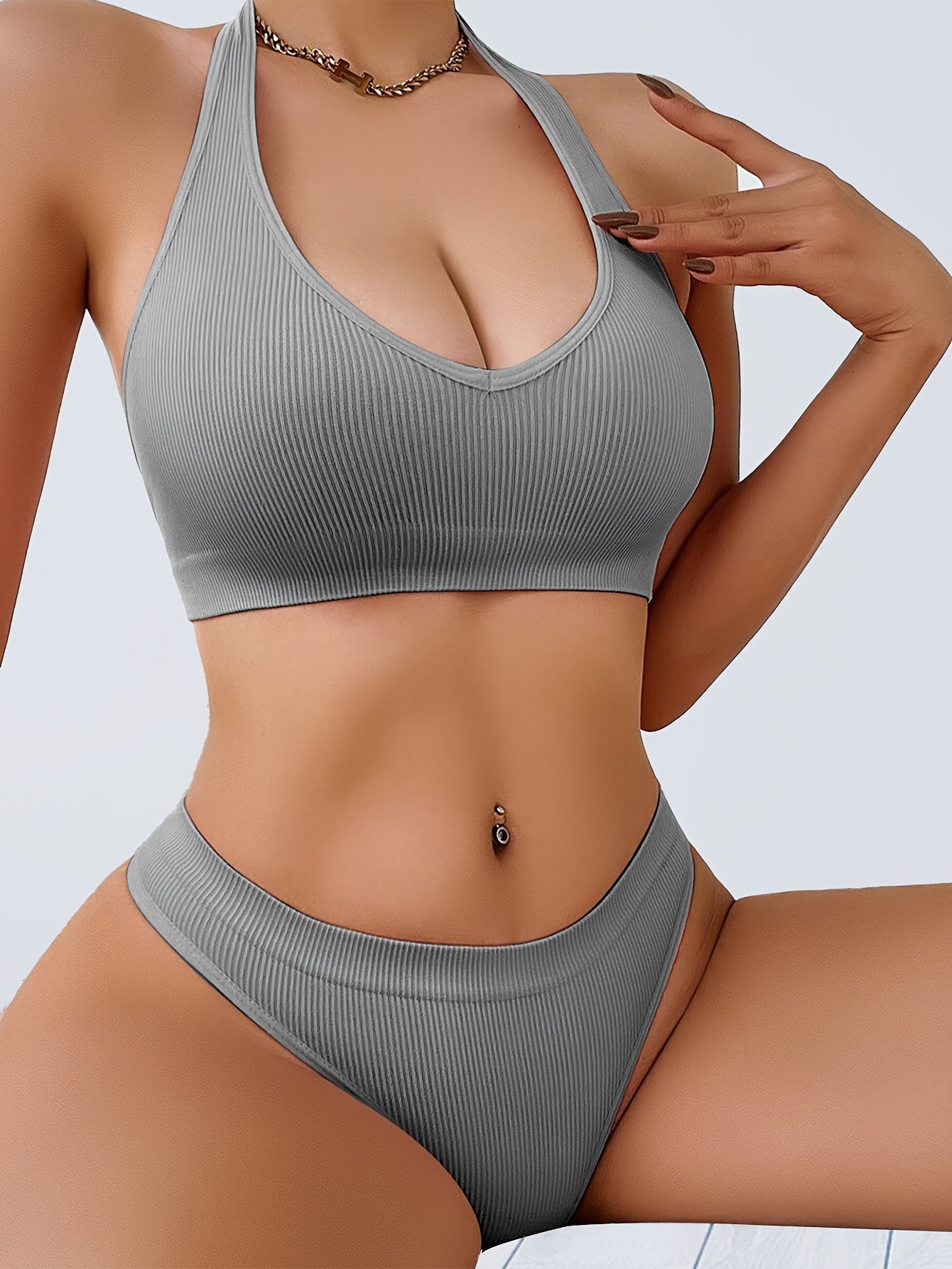 Two-piece women's camisole bra and panty set in solid color, made from knitted fabric with slight stretch. Comfortable and breathable sportswear with bra pads in the top.