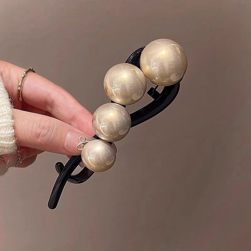 Stylish imitation pearl twist hairpin for daily wear and styling.