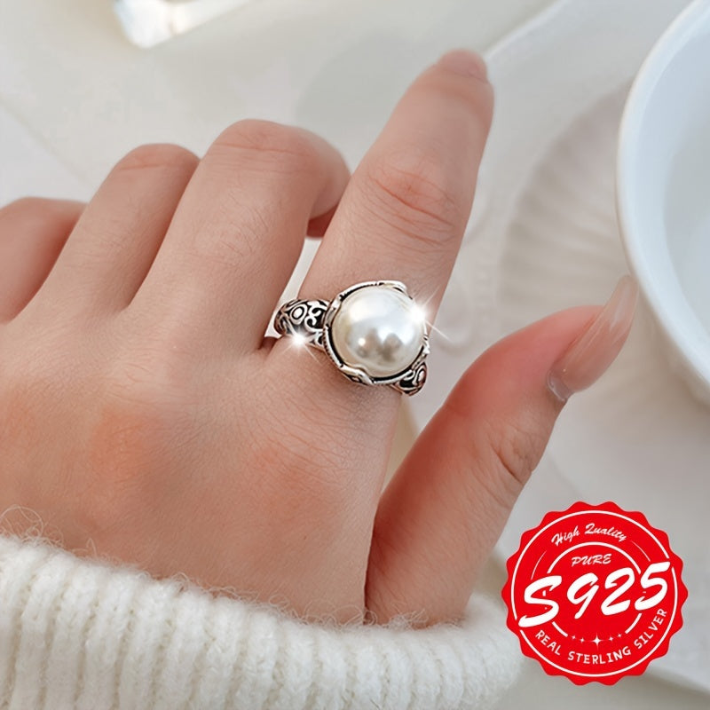 A stunning S925 sterling silver ring with a hollow carved imitation pearl, adorned with an antique Thai silvery design. This unisex Gothic style ring has an adjustable opening, making it perfect for any occasion. Lightweight at 4.16g, it is a great gift