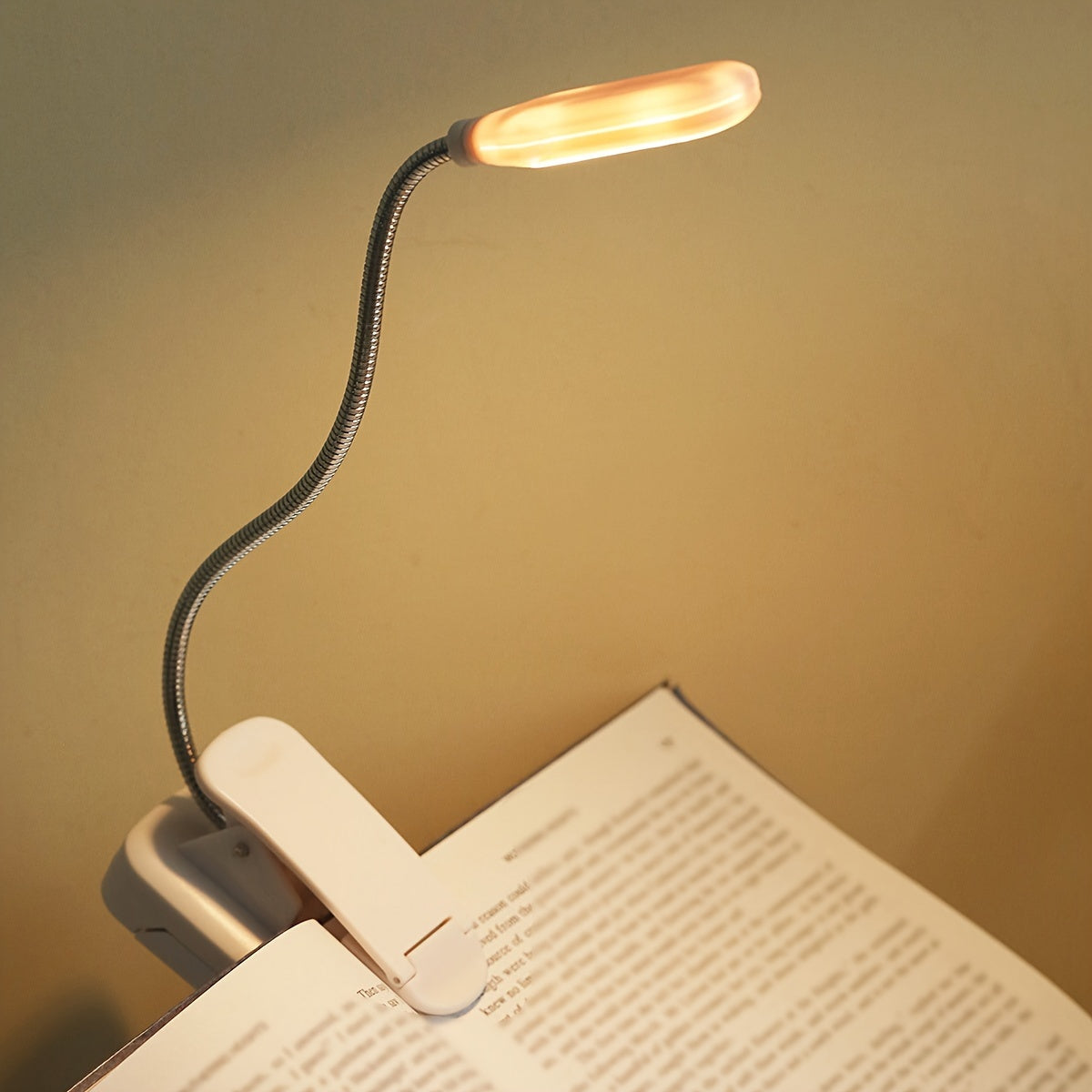 Portable battery-powered space-themed book light with adjustable arm, push button control, and uplight lighting, ideal for bedside use.