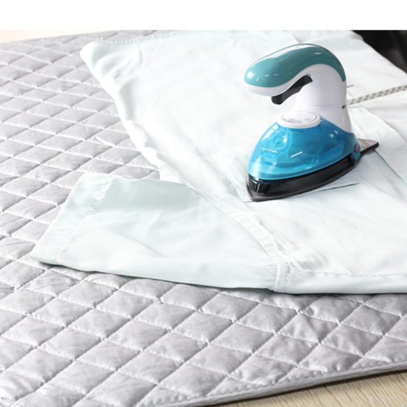 Portable Ironing Mat that does not require electricity, featuring a reusable heat-resistant cloth for pressing shirts and garments on-the-go. No need for an ironing board or plate, making it convenient for travel and home use.