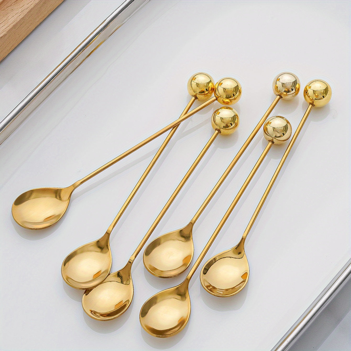 2 golden and silver round ball decorated dessert spoons, perfect for coffee, cake, and snacks.