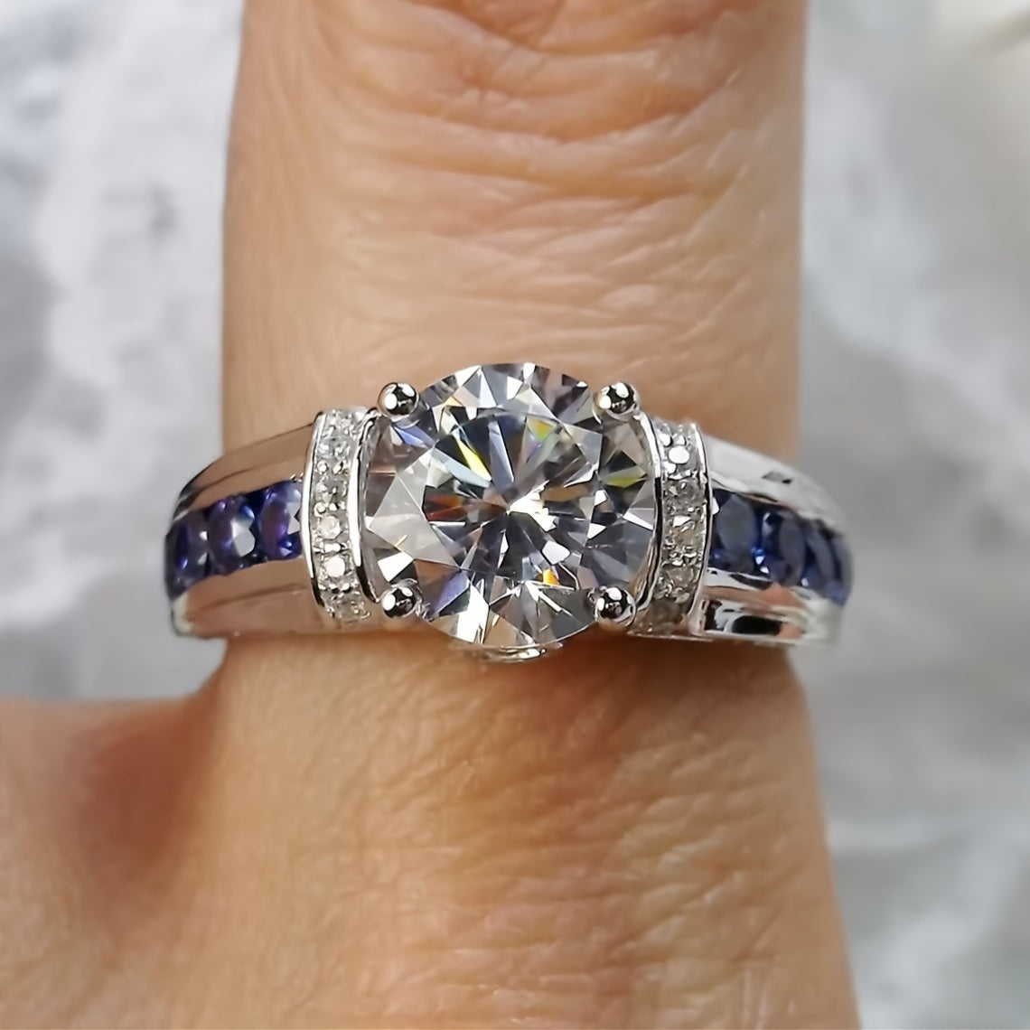 Beautiful 2ct Moissanite Engagement Ring adorned with stunning Blue Side Stones, crafted in 925 Sterling Silver Plating. This Boho Royal Style ring is ideal for both daily wear and special festival celebrations, making it a wonderful Mardi Gras gift.