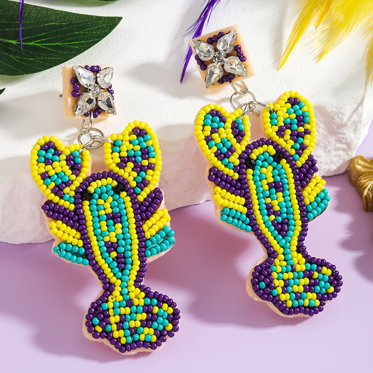 Mermaid-inspired beaded earrings with a Boho twist, adorned with colorful beads and rhinestones. Featuring a lobster claw design and stainless steel posts, these festive Mardi Gras earrings are perfect for daily wear or party occasions year-round.