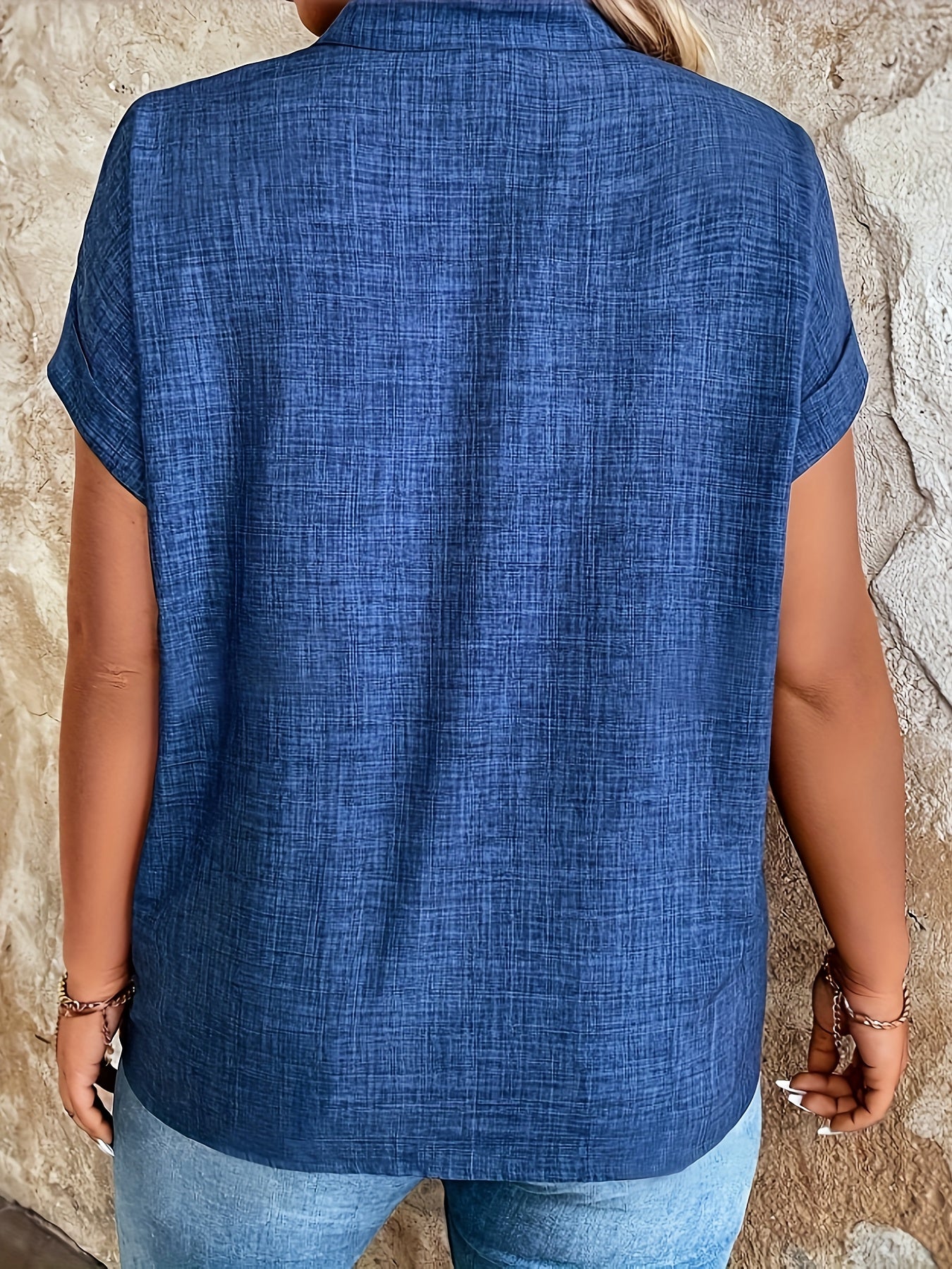 Elegant blue V-neck blouse with batwing sleeves, perfect for spring/summer. Made of machine washable polyester fabric, ideal for casual summer wear.