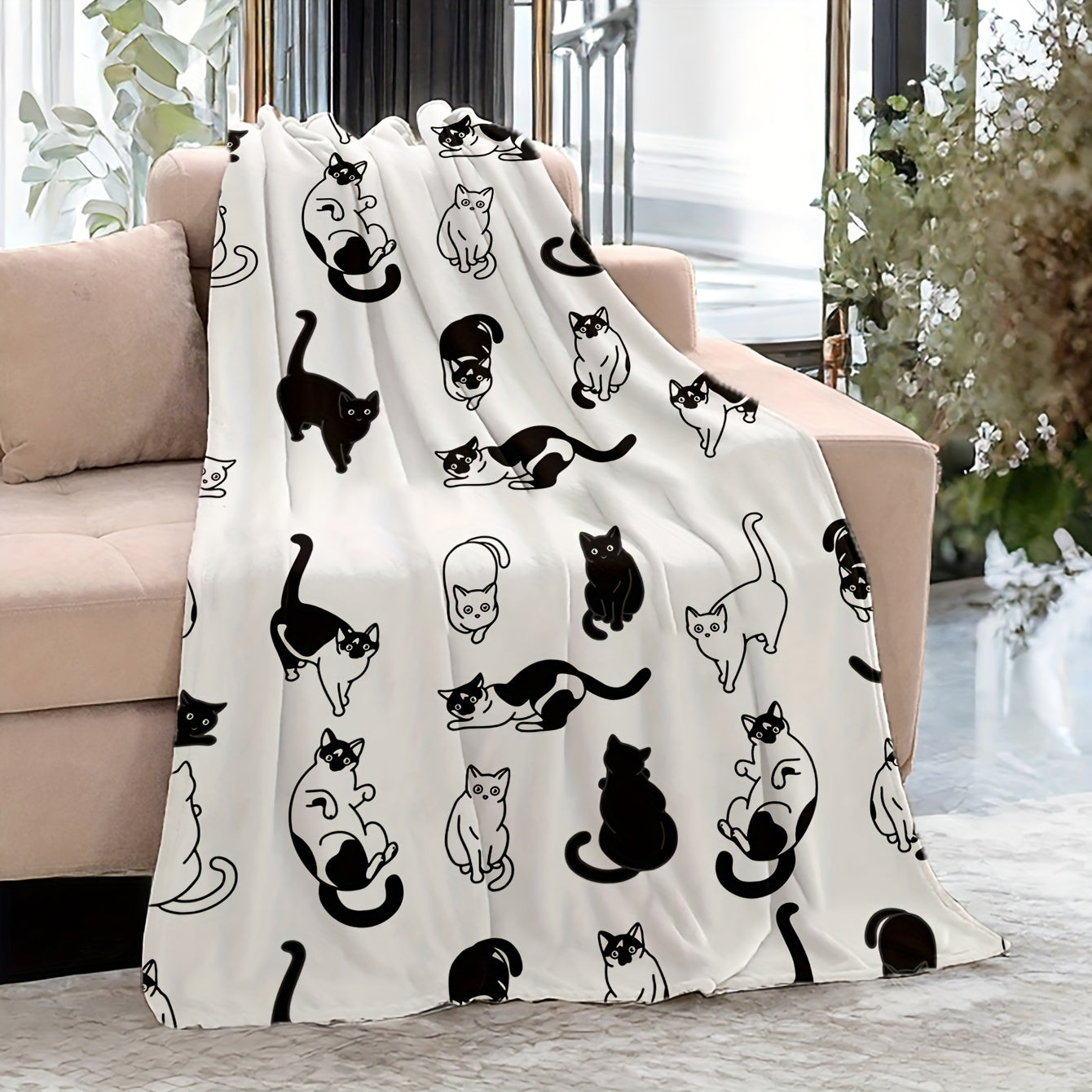 Soft and cozy fleece throw blanket featuring an adorable cartoon kitty print. Perfect for all seasons, this blanket is suitable for home, office, camping, and travel. Made from durable polyester fabric, it is machine washable for easy care. With a