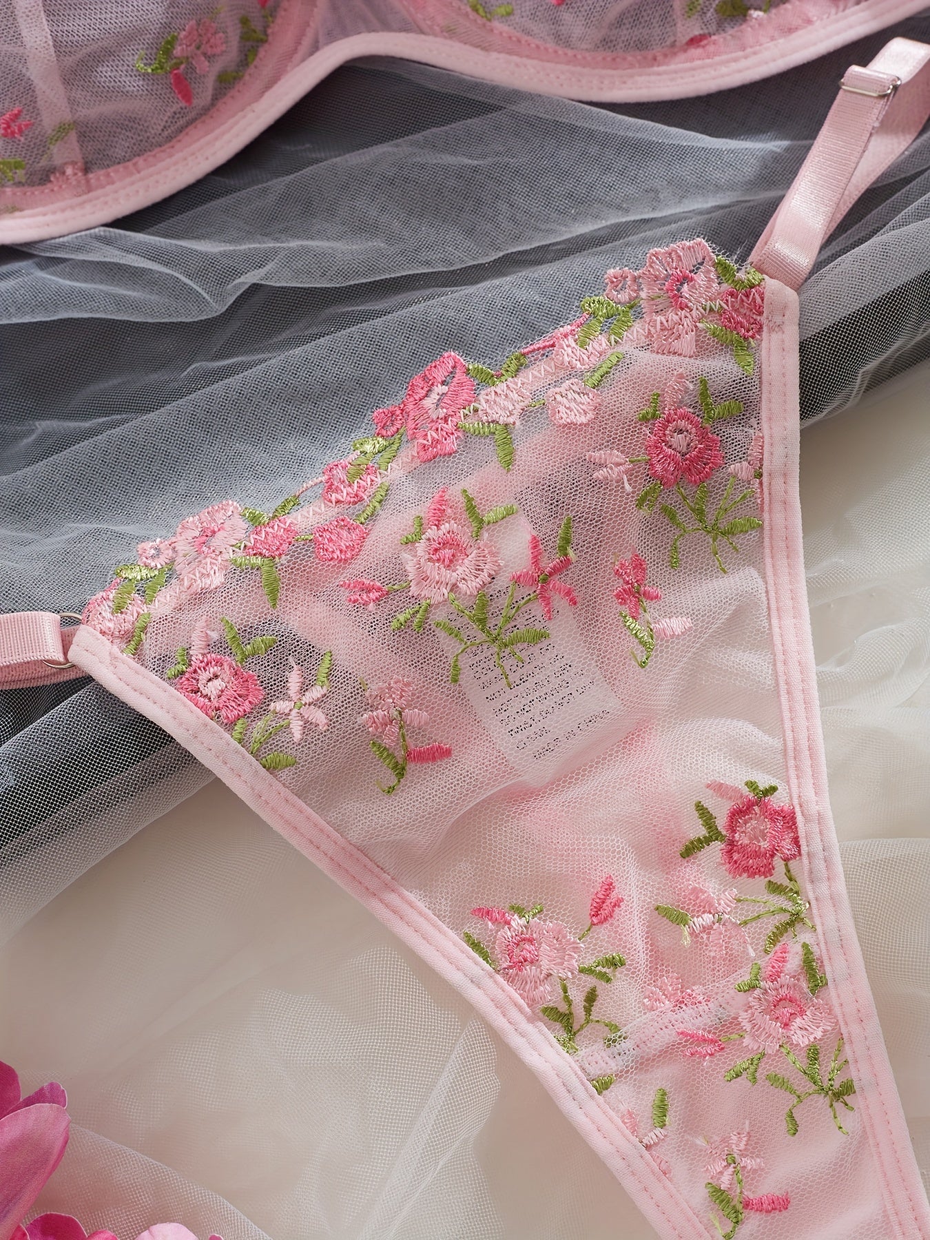 Chic French-inspired lingerie set in pink with floral embroidery and butterfly lace, featuring a sheer mesh bra and thong combo, medium support, hand wash only.