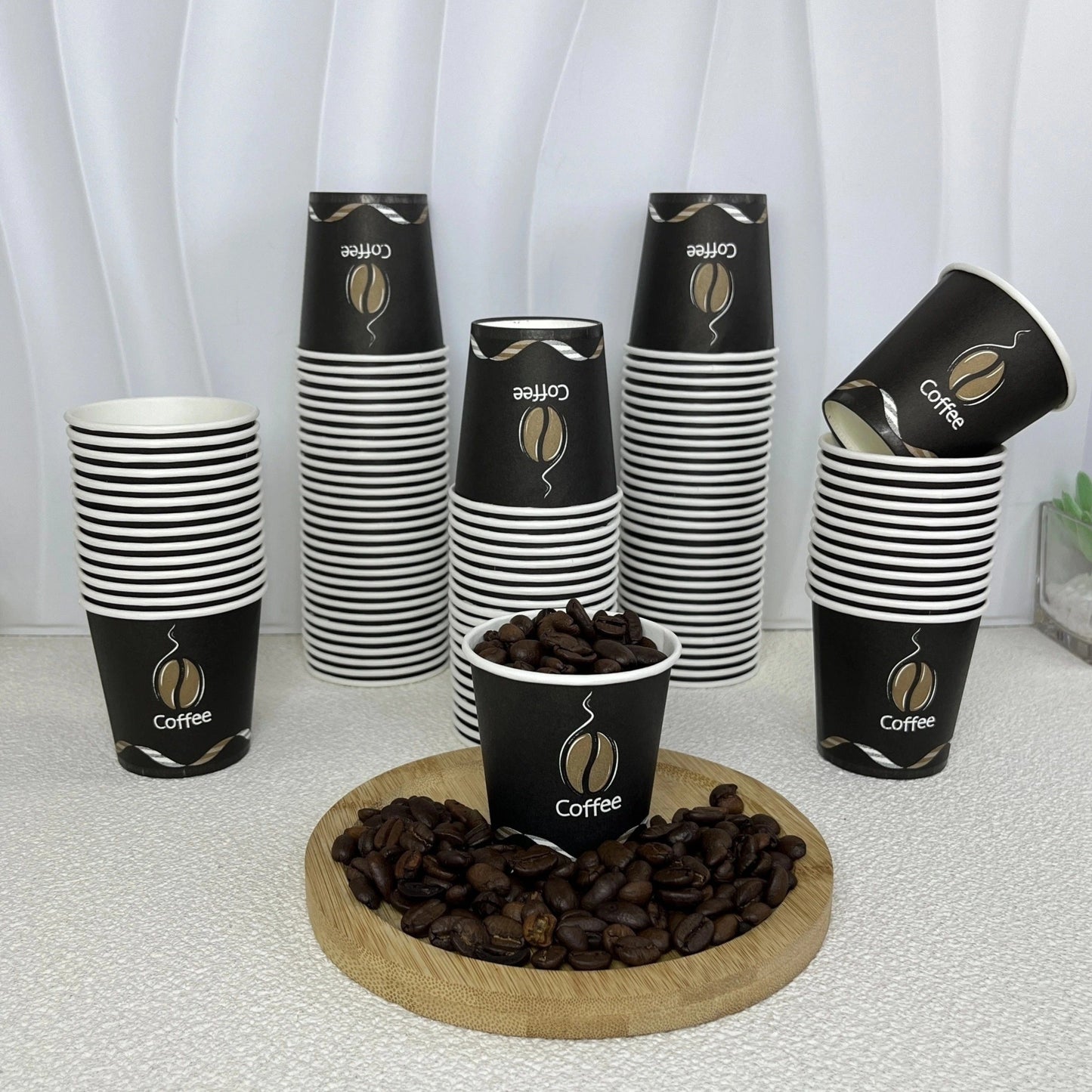 Pack of 50 disposable paper cups coated with poly, each holding 4oz. Versatile cups suitable for espresso, mouthwash, and snack tastings at home, office, or gatherings. Made of food-grade material and recommended for hand washing. Package includes 200