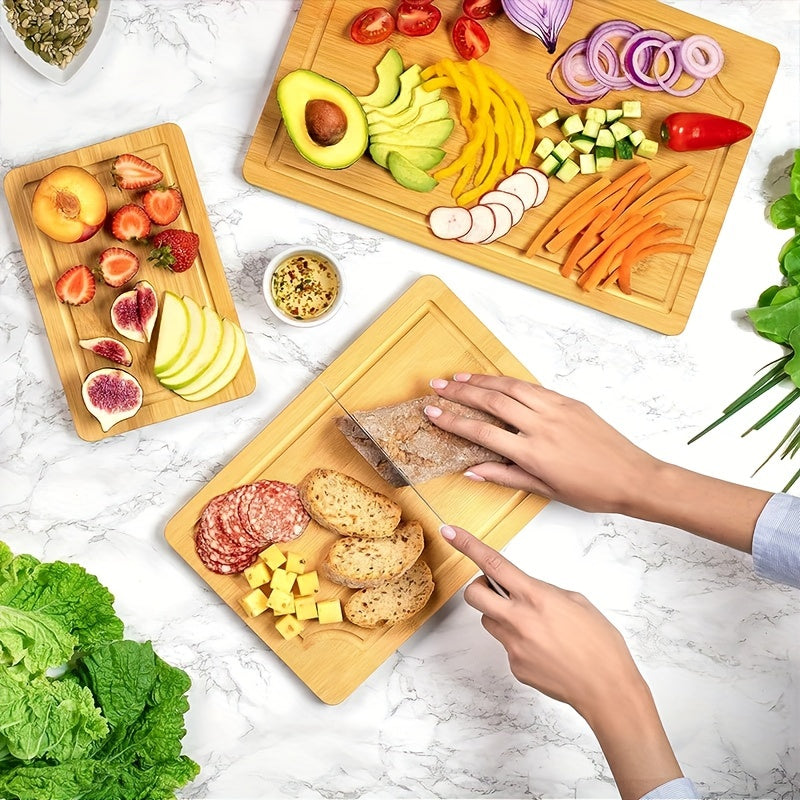 Set of 3 bamboo cutting boards with juice grooves, perfect for chopping meat and veggies. Features easy grip handles and makes a great kitchen gadgets gift.