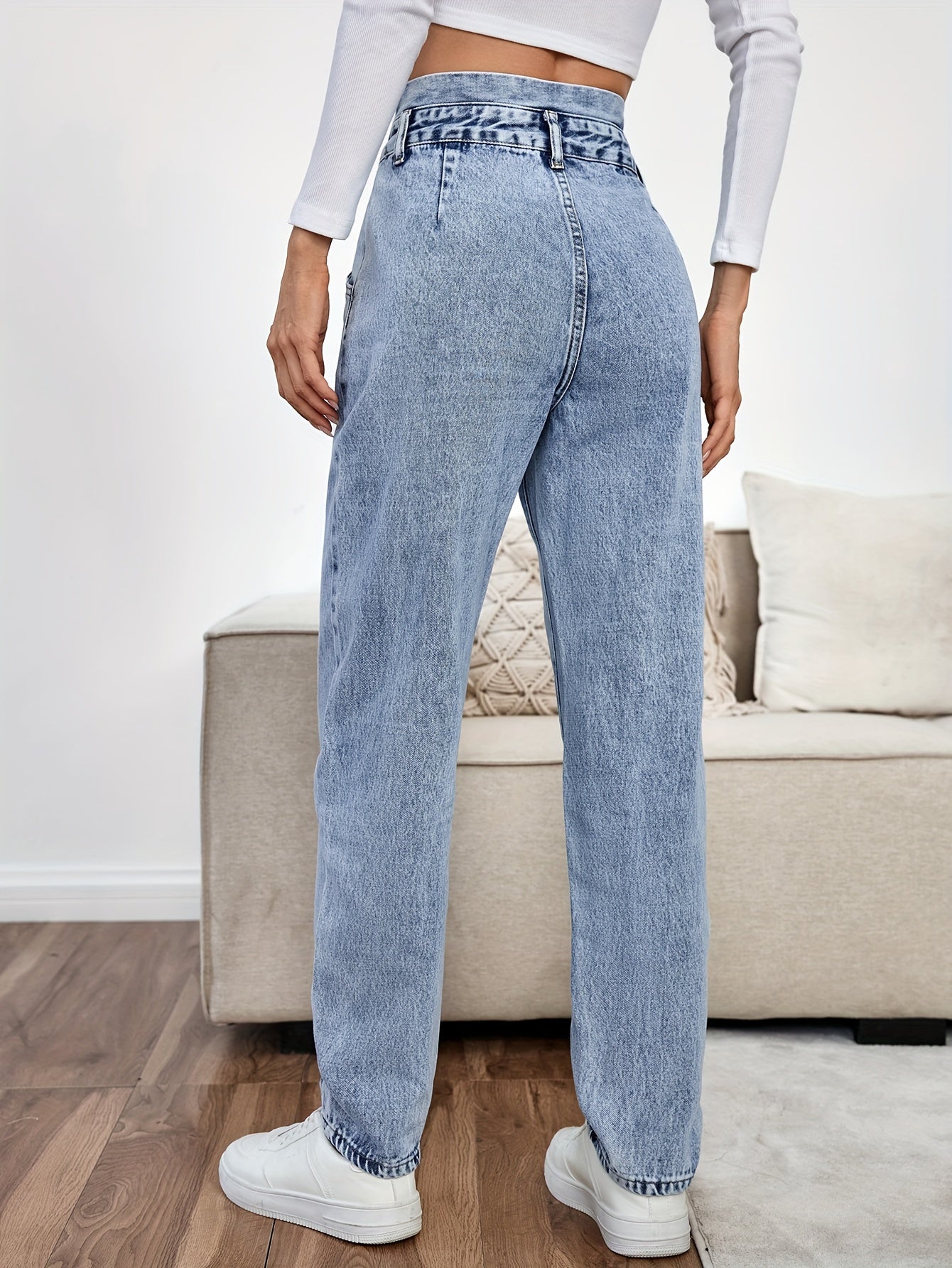 Women's light blue high-waisted straight-leg denim jeans with slash pockets, button closure, and non-stretch cotton material for casual spring/fall wear.