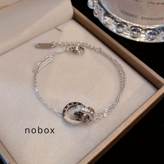 A set of four pieces of stainless steel jewelry featuring silvery precious stones and Roman numerals in a simple, trendy design. This versatile set includes a bracelet, necklace, and earrings, perfect for daily wear or a retro, light luxury holiday