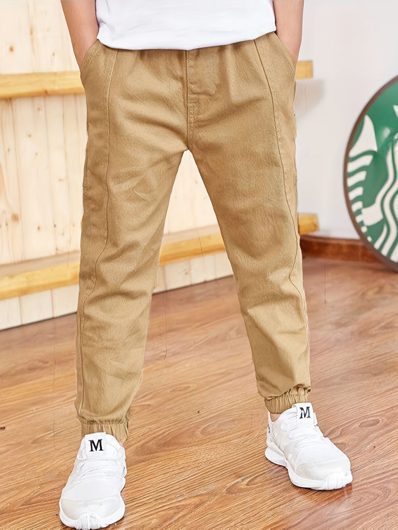 Boys' slim fit khaki cargo pants made with a durable cotton blend, featuring an elastic waist and pockets. Ideal for hiking, sports, and everyday wear.