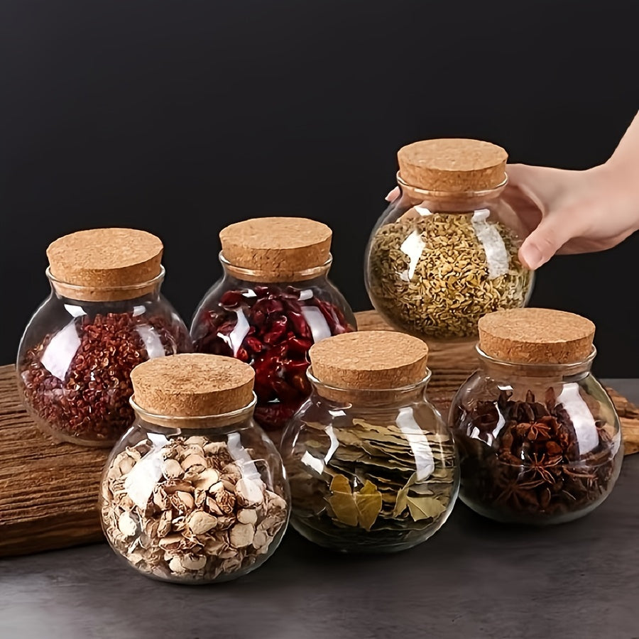 This glass storage jar with cork lid holds 16.9oz and is perfect for storing various items in your kitchen. Made of BPA-free and heat-resistant materials, it is a versatile canister that can be used for storing coffee beans, tea, flour, sugar, and more.