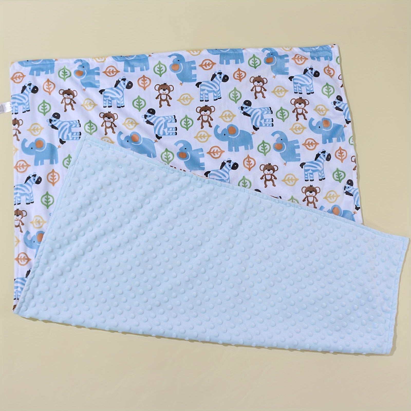 Soft and cozy Playful Pals Youngsters' Beanie Blanket featuring adorable Lion and Elephant Print. Ideal for year-round use, easy to care for with machine washable convenience. Choose from Gray, White, Pink, or Blue color options.