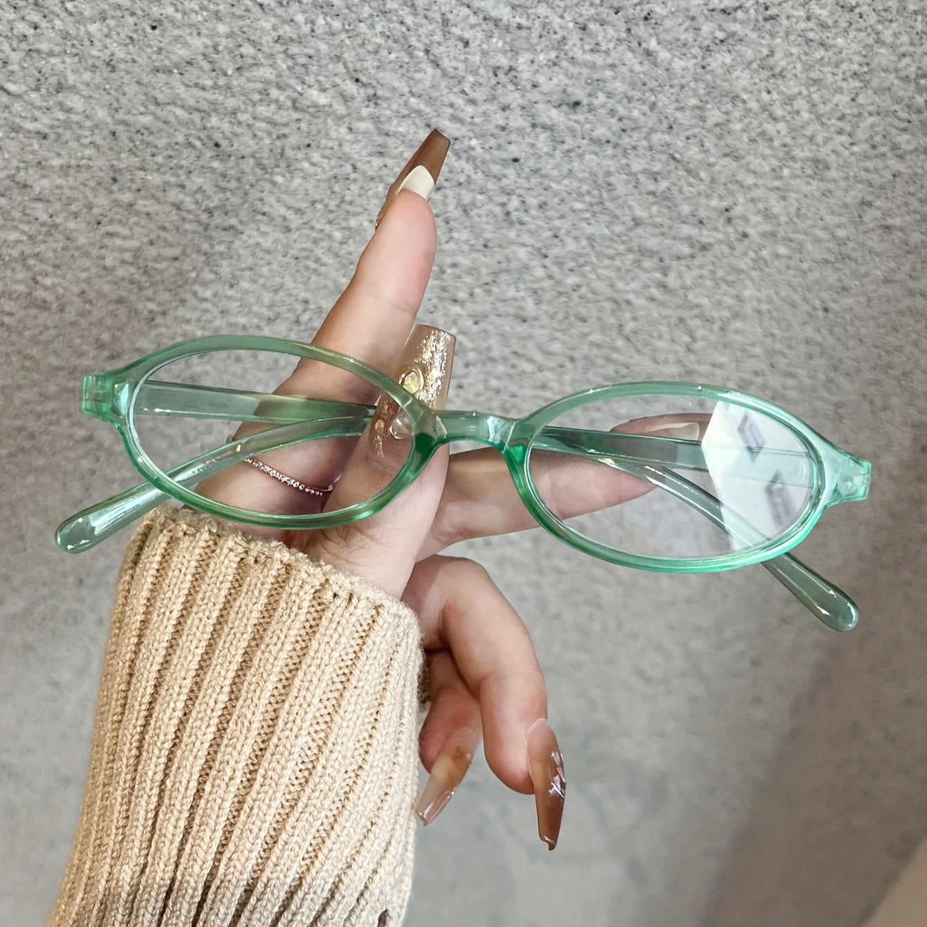 Fashionable oval frame clear lens glasses for women made of polycarbonate with a full rim, featuring a transparent gradient design. Perfect for parties or as stylish computer glasses to