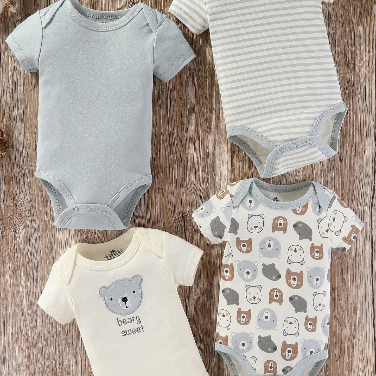 Baby boy's short sleeved cotton jumpsuit featuring plain color, stripes, bear embroidery, and bear heads print. Soft, breathable, and perfect for summer daily and outdoor wear.