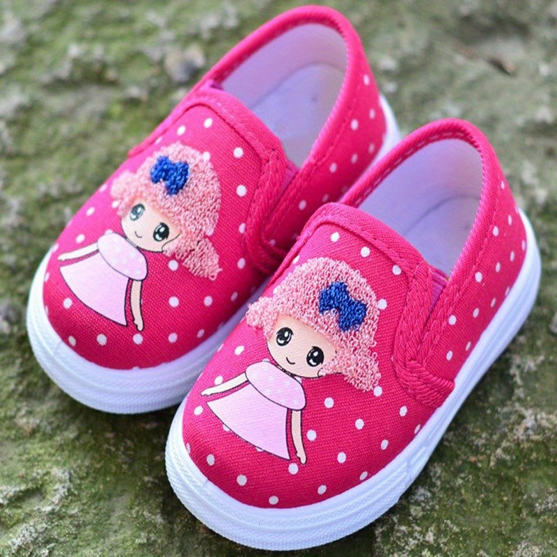 Adorable pink polka dot slip-on canvas shoes for girls featuring cute cartoon embroidery, breathable fabric, lightweight and comfortable for spring and fall. Durable TPR sole and easy