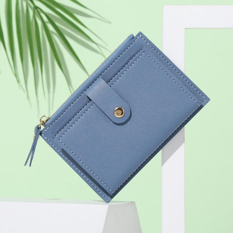 Slim short wallet for women with zipper closure, bifold design, credit card slots, coin purse, and solid color.