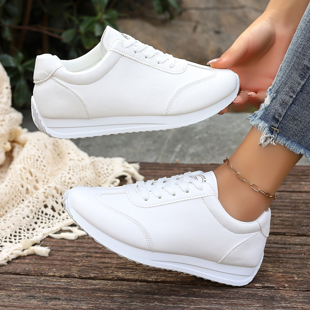 White synthetic leather women's casual sneakers with stability support, all-season comfort, and breathable fabric lining. Perfect for casual attire.