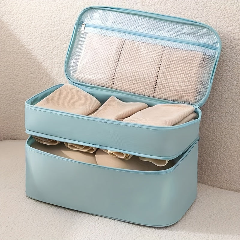 Travel underwear and bra organizer bag with double-layer design and divided compartments. Made of beige polyester fabric with a mesh interior. Ideal for dorms, trips, and daily use. Hand