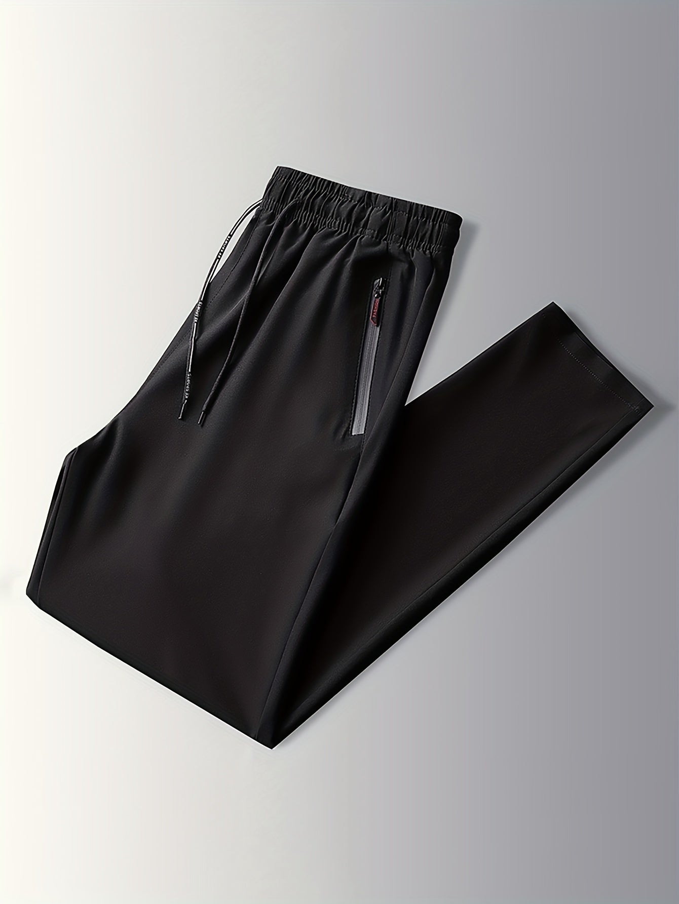 Men's Plus Size Casual Black Joggers, made of breathable, lightweight polyester with zipper pockets and a drawstring waist. Ideal for sports and leisure in spring/summer.