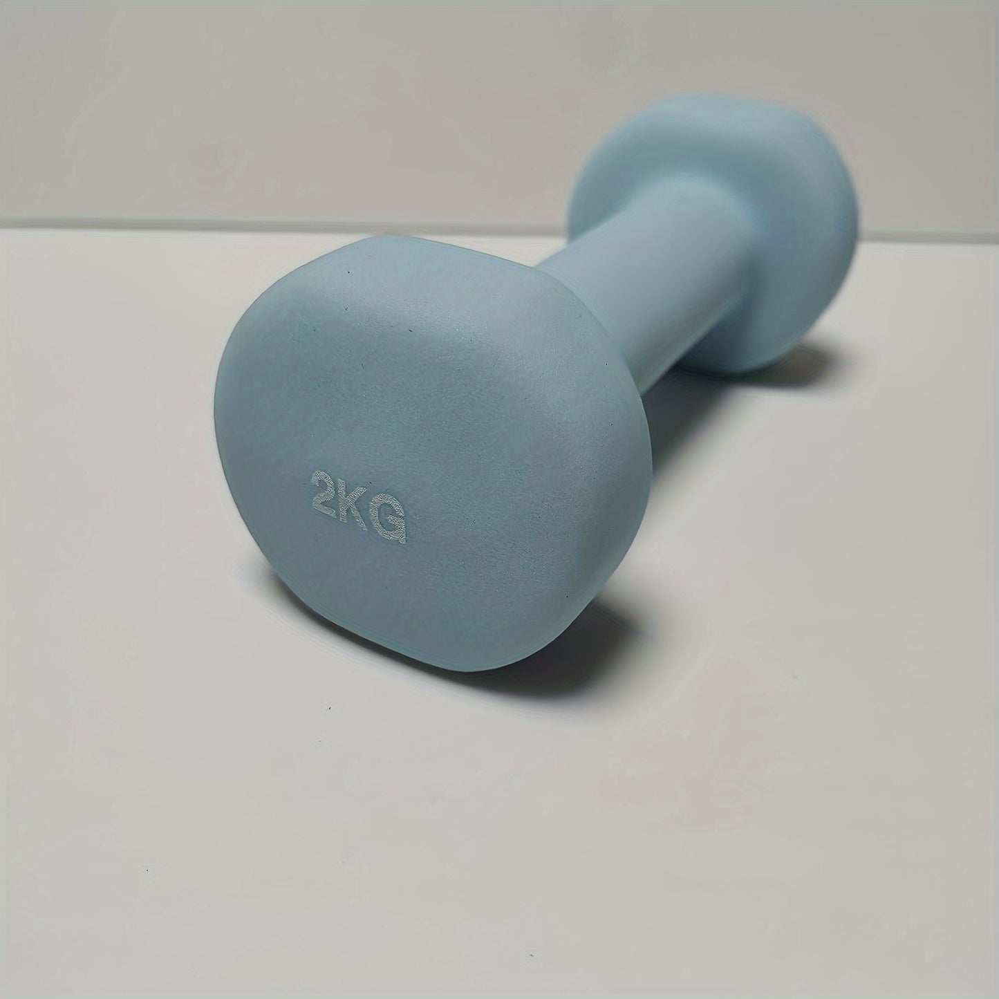 1pc 2kg dumbbell in pink/blue/black colors, made of solid cast iron for home gym. Durable and stylish fitness accessory for both men and women.