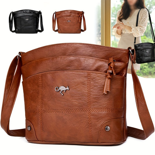 Vintage-style women's shoulder bag in light brown/black with adjustable strap, multiple compartments and tassel decoration.