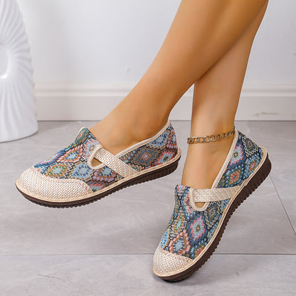 Women's printed slip-on mules with soft, lightweight soles.